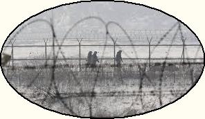 Camp 14 Guards patrol barbed fence in bleak winter